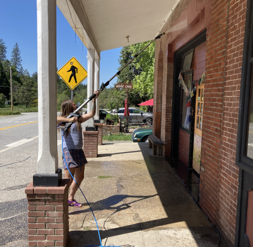Michael Blackwell, pressure washing his storefront.
